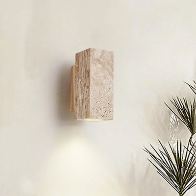 Applique murale Wabi Sabi en travertin gris avec éclairage LED allumé dans une chambre