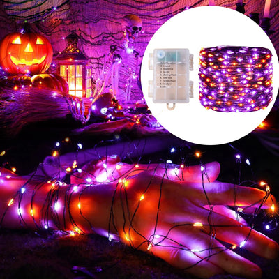 Guirlande lumineuse LED 20m violette et orange allumée dans un jardin de nuit