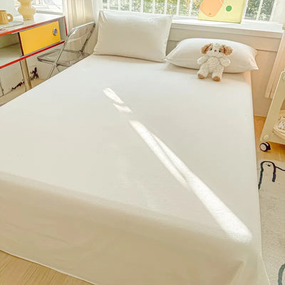 Drap de lit en coton percale bio couleur bourgogne sur un lit