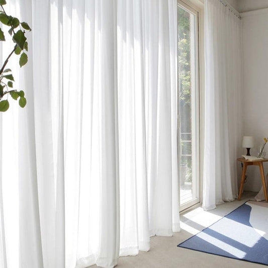 Des rideaux blancs, simples et élégants, apportant luminosité et sobriété à votre intérieur.