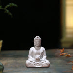 statue bouddha zen blanc gris bois décoratif assiette cigarettes tapis fibres naturellements éléments divers