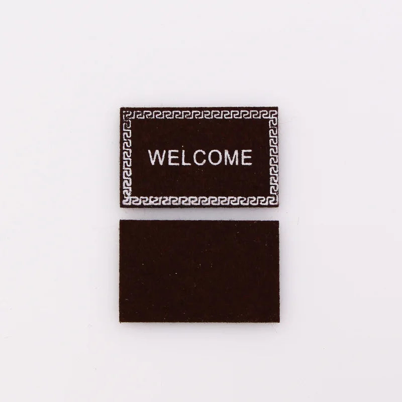 tapis d'entrée marron gris rose motif géométrique adhésif classique