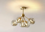 lustre moderne lumières doré sphères transparentes art déco contemporain led chambre salon