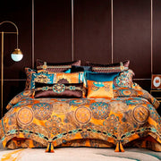 ensemble literie luxueux motifs géométriques couleurs orangées bleues noires tissu opulent couverture taies oreillers