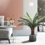 plante artificielle moderne feuilles vertes tronc texturé pot noir décoration intérieure feuilles fines branche