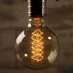 ampoules filament transparentes spirales dorées vintage rétro salon tringles câbles noirs
