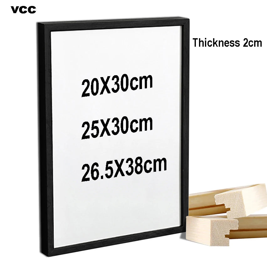 Cadre photo en bois naturel noir sur mur blanc