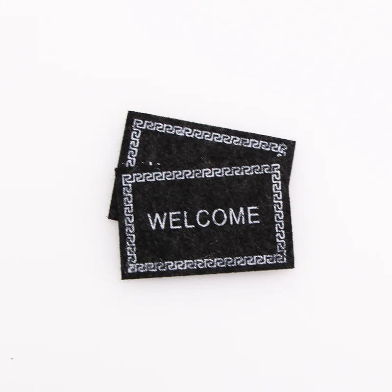 tapis d'entrée marron gris rose motif géométrique adhésif classique