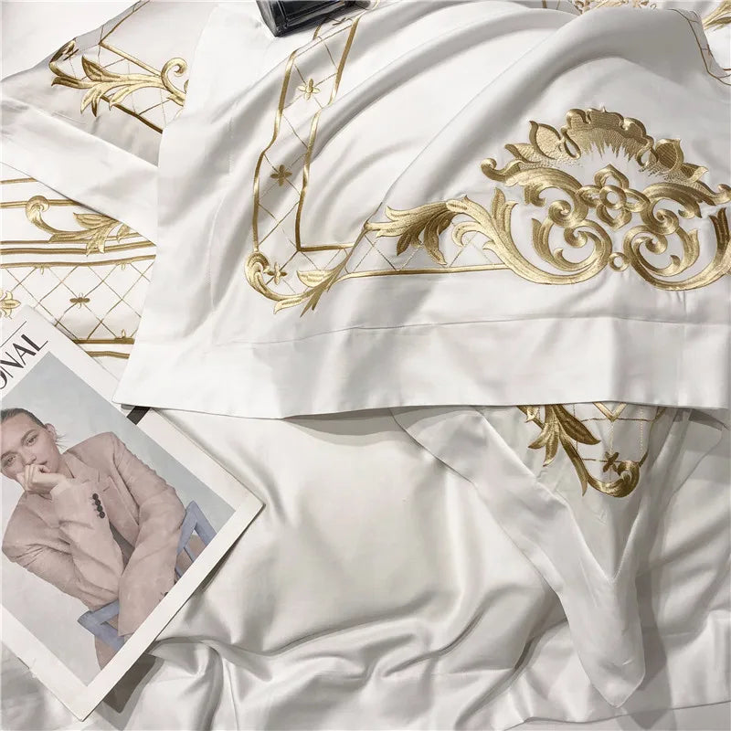 Parure de lit complète étalée montrant housse, drap et taies