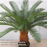 plante artificielle moderne feuilles vertes tronc texturé pot noir décoration intérieure feuilles fines branche