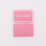tapis d'entrée marron gris rose motif géométrique adhésif classique