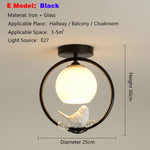 lampe moderne or noir oiseaux dorés branches sphère blanche translucide led echangement facile