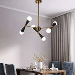lustre suspension moderne or noir 12 sphères blanches structure métallique