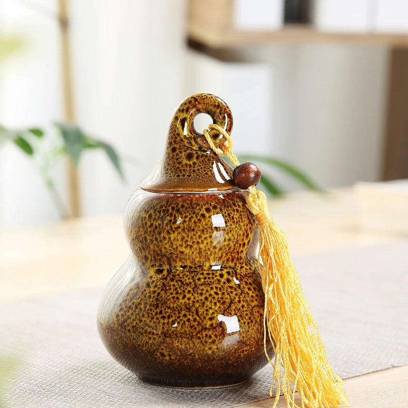 pot thé céramique vert brun artisanal couvercle anneaux pompon décoration maison stockage épices