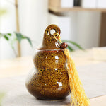 pot thé céramique vert brun artisanal couvercle anneaux pompon décoration maison stockage épices