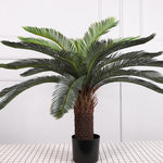 plante artificielle moderne feuilles vertes tronc texturé pot noir décoration intérieure feuilles fines branche