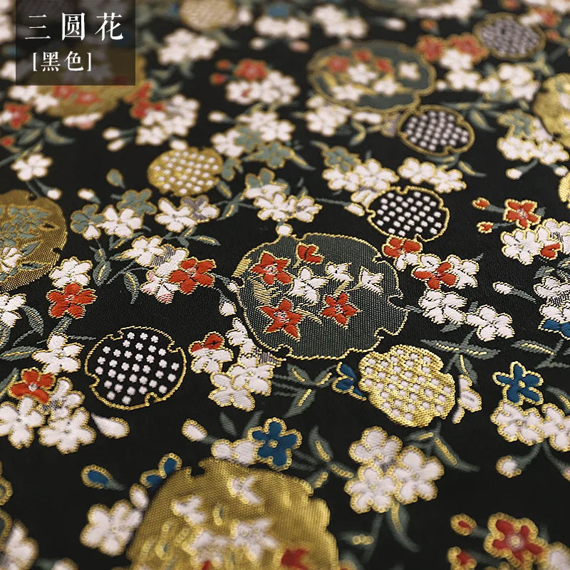 tissu traditionnel japonais brocart fleurs cerisier motifs géométriques noir rose pâle rouge vif