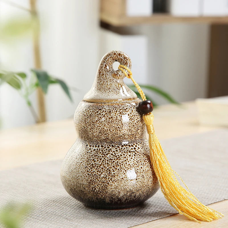 pot thé céramique vert brun artisanal couvercle anneaux pompon décoration maison stockage épices
