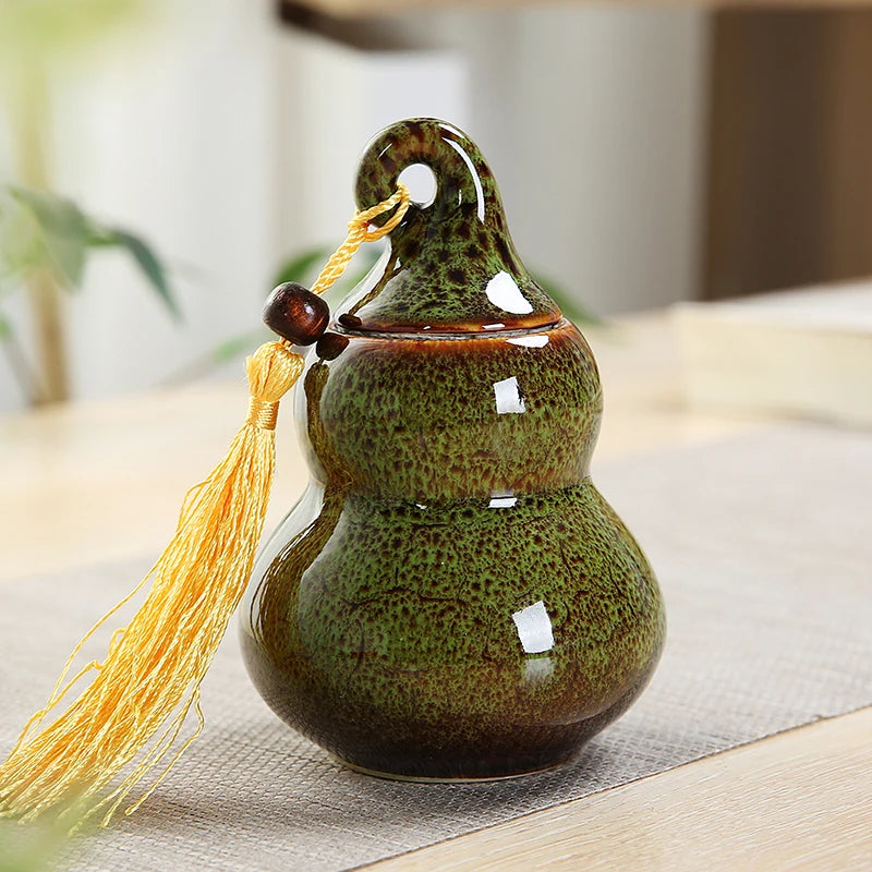 pot thé céramique vert brun artisanal couvercle anneaux pompon décoration maison stockage épices