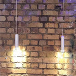 lampe suspendue or rose moderne facettes géométriques câble noir chambre salon