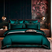 ensemble literie luxueux vert émeraude taies d'oreiller bordées couverture brillante moderne