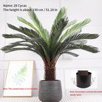 plante artificielle moderne feuilles vertes tronc texturé pot noir décoration intérieure feuilles fines branche