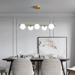 Suspension lumineuse moderne or blanc sphères blanches structure dorée salon chambre