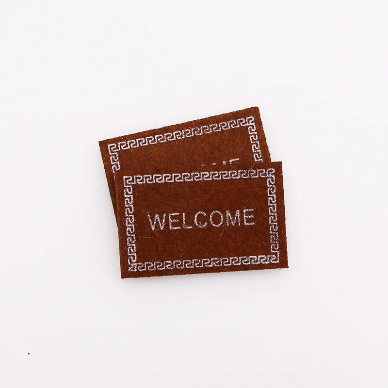 tapis d'entrée marron gris rose motif géométrique adhésif classique