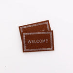 tapis d'entrée marron gris rose motif géométrique adhésif classique