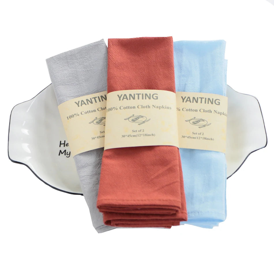 Serviettes de table en coton 100% de la marque Yanting dans différentes couleurs.
