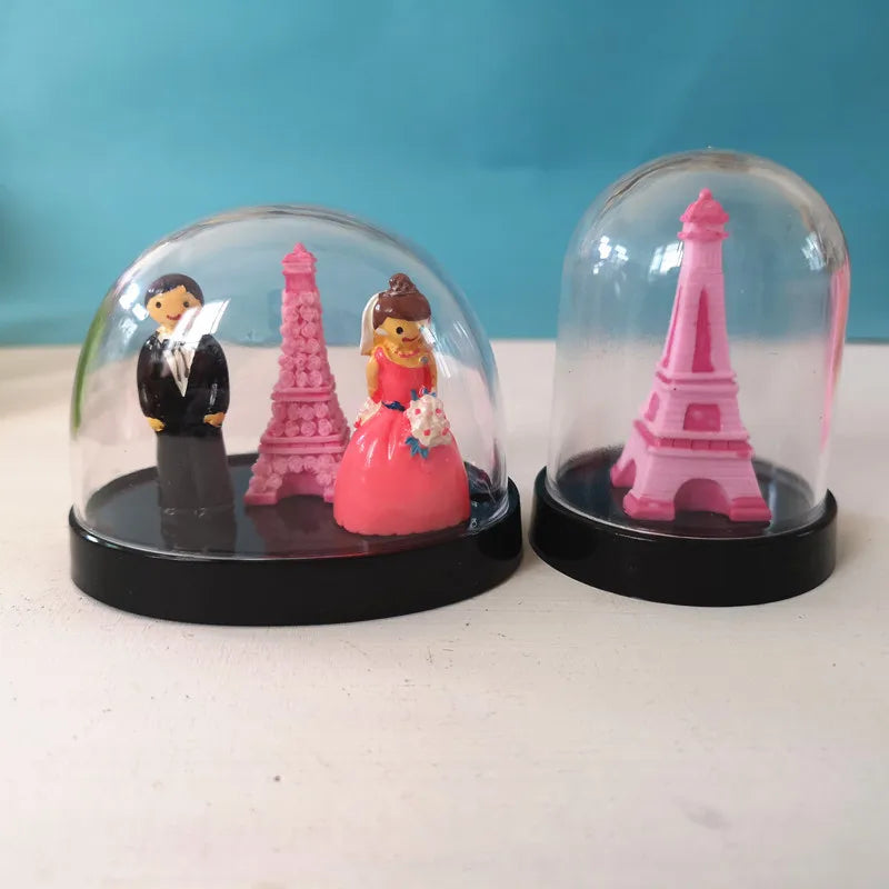 ornements transparents noir rose tour eiffel figurines branches dorées cloches bases circulaires décoration mariage