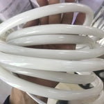 Tube néon LED blanc chaud illuminant une tête de lit