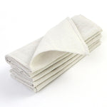 Serviettes blanches pliées en coton souple et absorbant, prêtes à être utilisées.