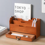 Boîte de rangement bureau en bois placée sur un bureau avec stylos et documents