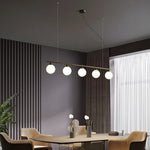 suspension lumineuse or blanc sphères translucides barre horizontale moderne minimaliste chambre salon