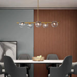 Suspension lumineuse moderne or blanc sphères blanches structure dorée salon chambre