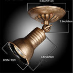 Spot bronze led éclairage industriel vintage texture métallique gravure fixations vis