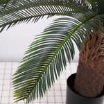 plante artificielle moderne feuilles vertes tronc texturé pot noir décoration intérieure feuilles fines branche