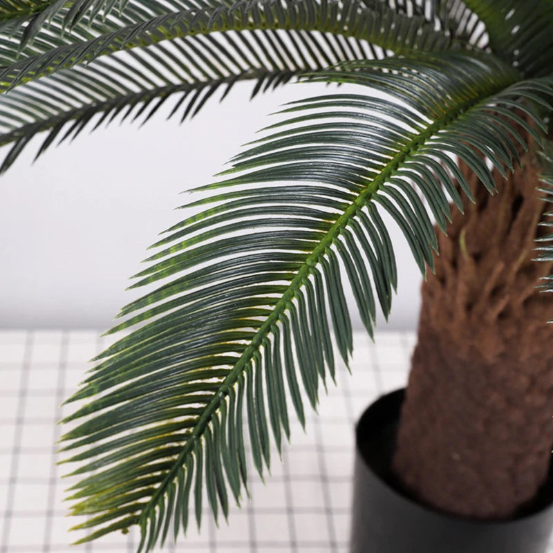 plante artificielle moderne feuilles vertes tronc texturé pot noir décoration intérieure feuilles fines branche
