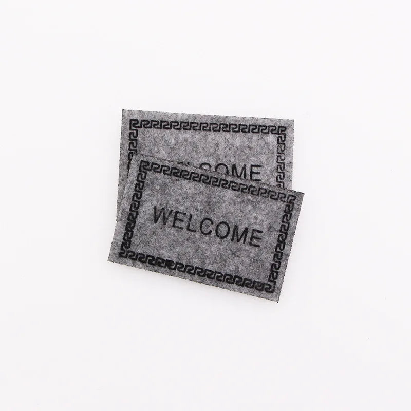 tapis d'entrée marron gris rose motif géométrique adhésif classique
