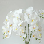 décoration intérieure orchidées artificielles blanc rose jaune feuilles vertes minimaliste mariage anniversaire baby shower