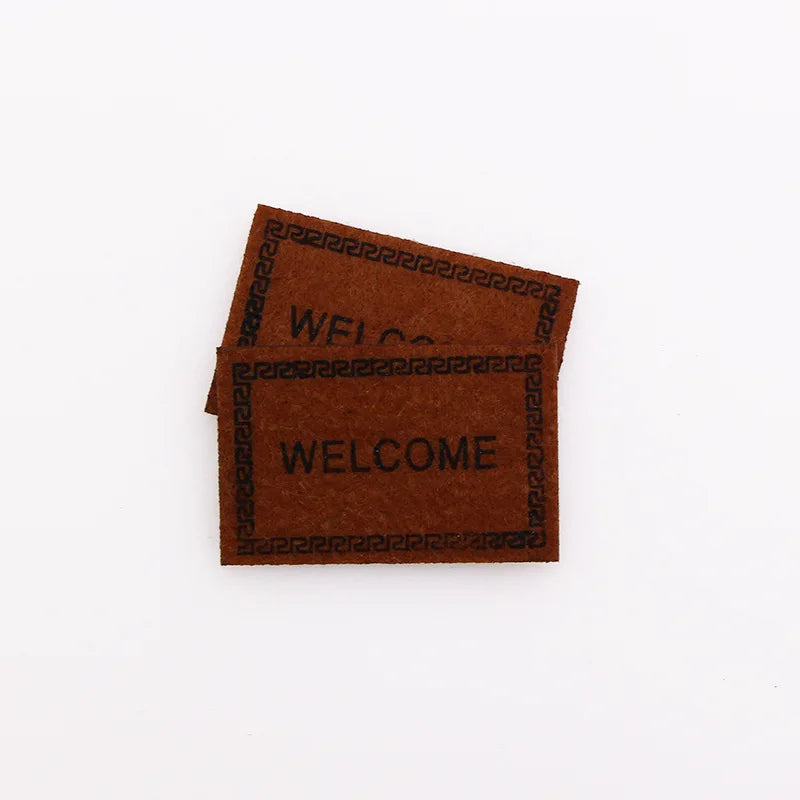 tapis d'entrée marron gris rose motif géométrique adhésif classique