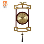 horloge murale bois chinois cadres dorés marron motif géométrique aiguilles dorées classique