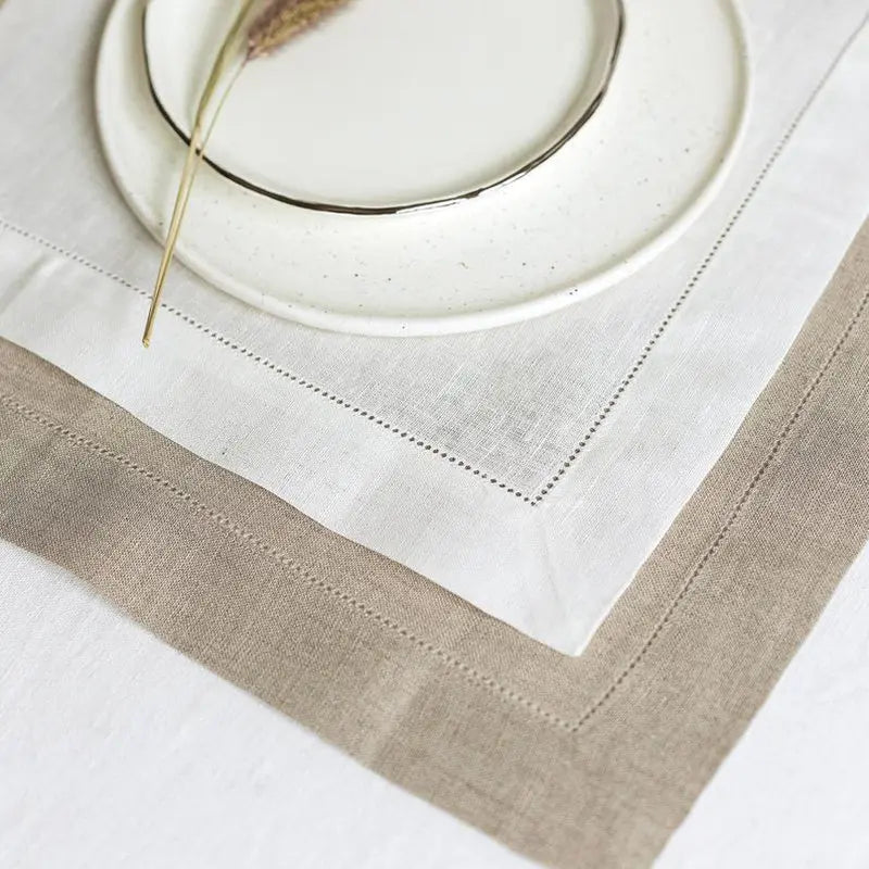 Un service élégant avec une nappe blanche et des détails gris.