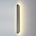 Applique murale LED noire design moderne allumée dans une chambre