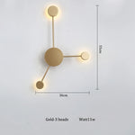 lampes murales modernes abstrait cercles tiges métalliques noir doré minimaliste têtes