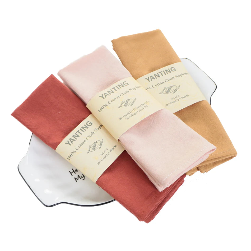 Ensemble de serviettes en coton de couleurs vives et variées, comprenant une tasse à thé blanche.