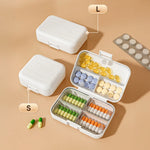 boîte pilules moderne blanc rose compartiments semaines verrouillable pratique adhésif organisateur médicaments portable