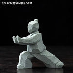 statues arts martiaux traditionnelles gris clair texture granite opaques artisanal modernes motifs traditionnels