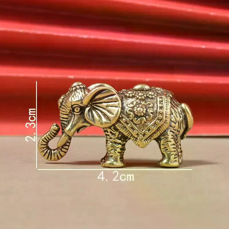 statuette éléphant bronze doré décoration florale motifs géométriques texture rugueuse traditionnel asiatique ornement métallique